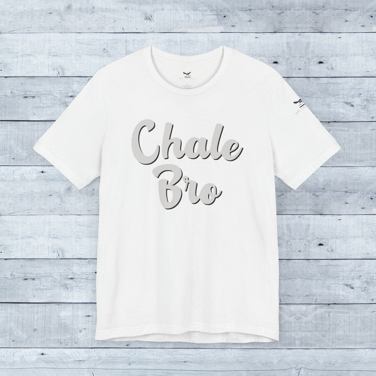 White relaxed fit tee with "Chale Bro" in gray cursive script across front.