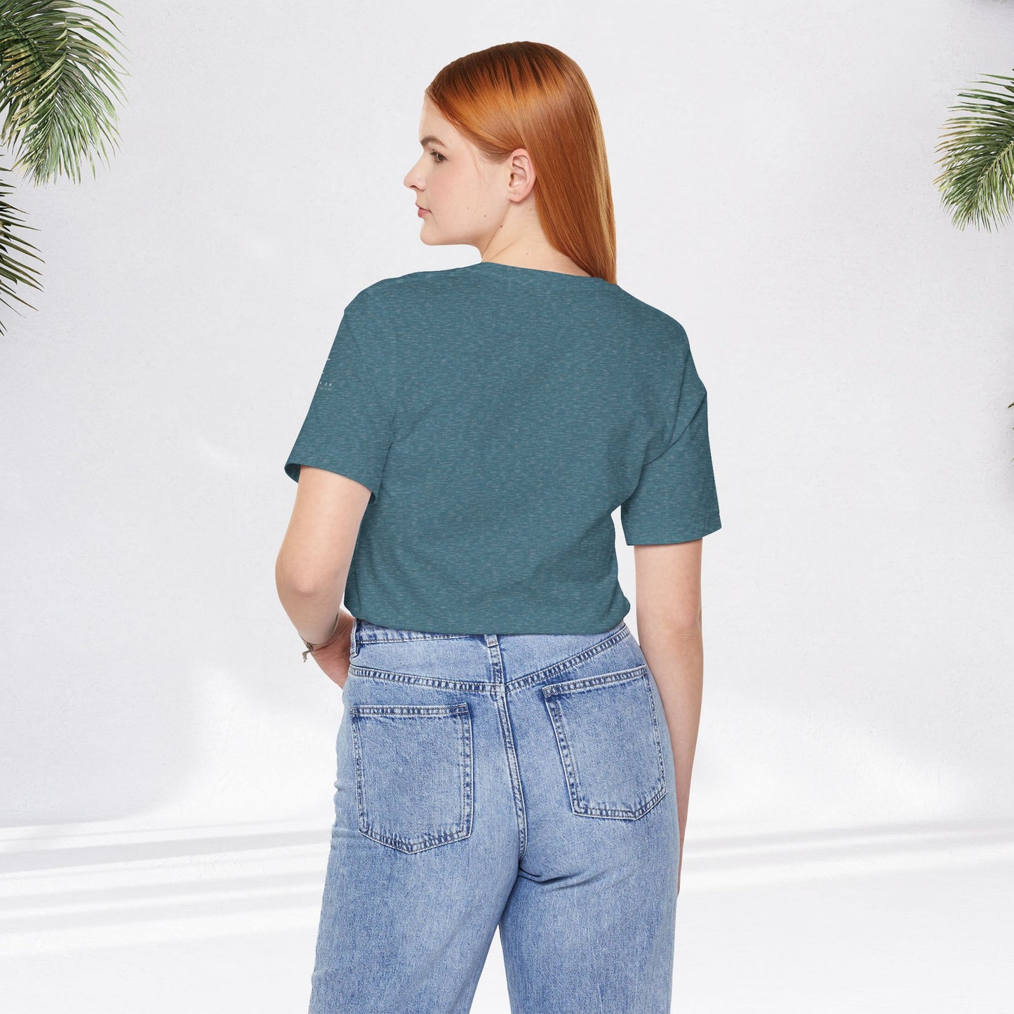 Heather deep teal relaxed fit tee paired with light blue high-waisted jeans viewed from back.