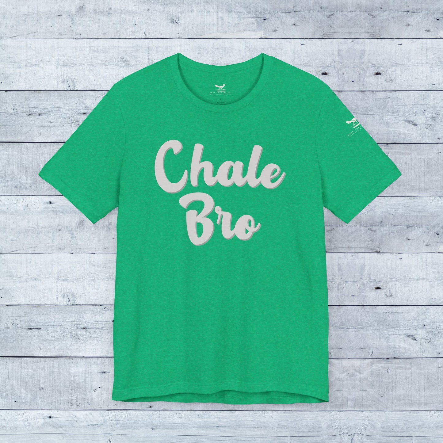 Heather Kelly green unisex tee with playful "Chale Bro" slogan in light beige cursive font.
