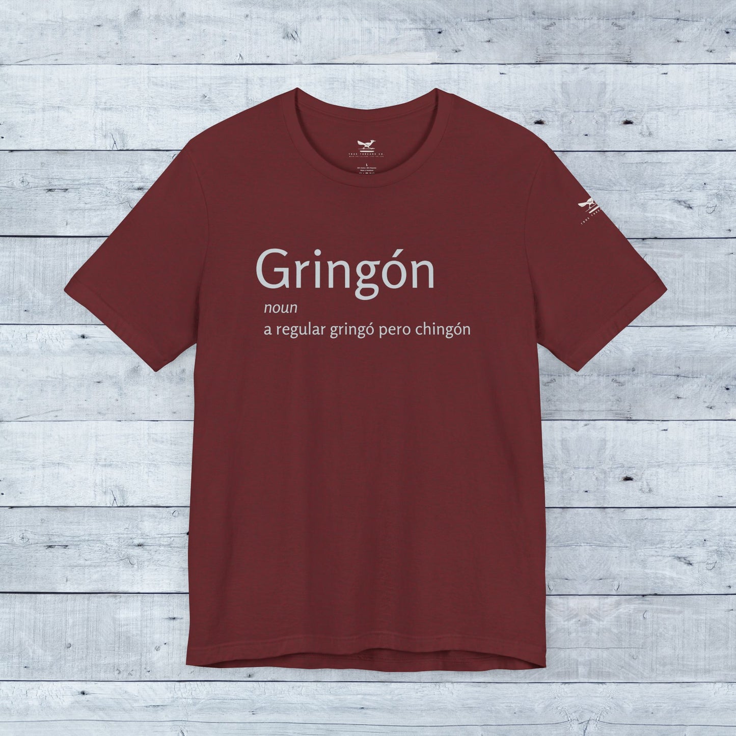 Gringón Tee featuring bold white text on a red background, crafted from soft tri-blend fabric, designed for comfort and style, suitable for casual wear.