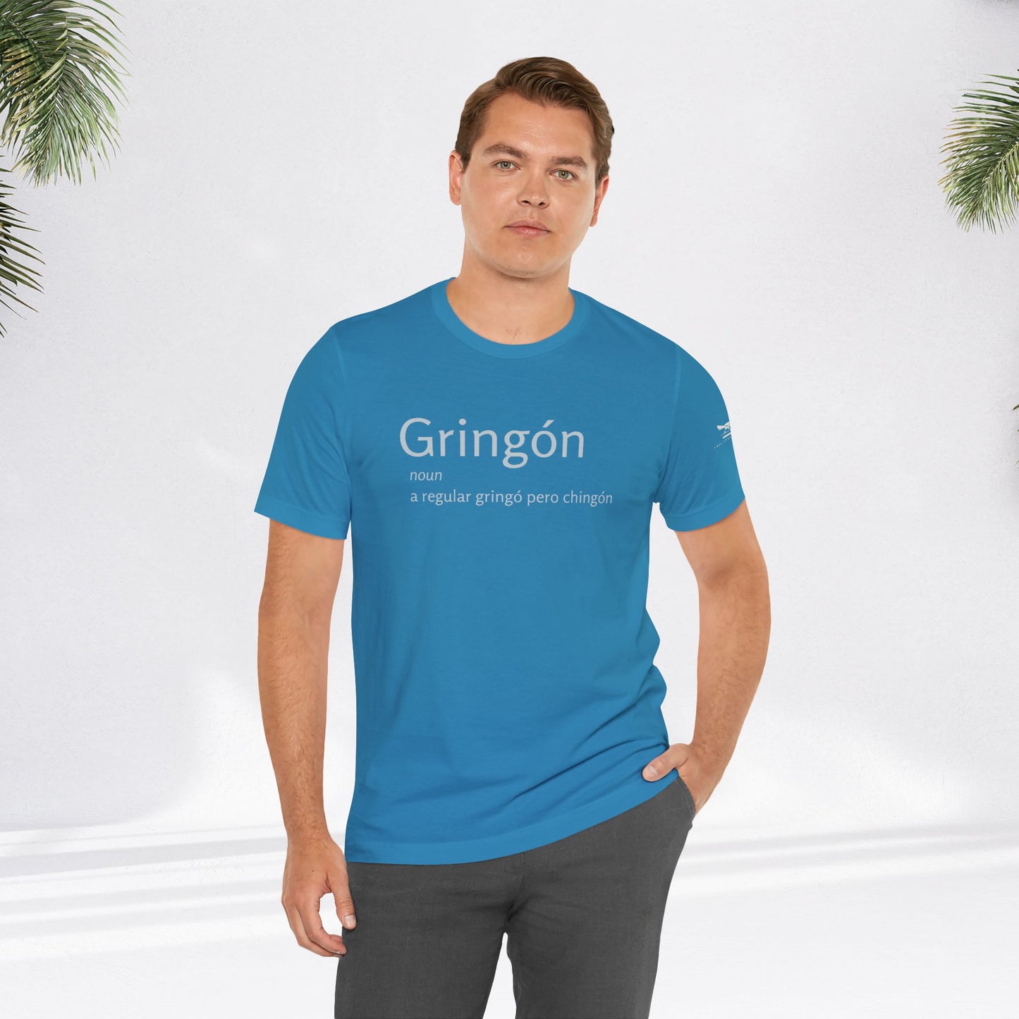 Man wearing blue Gringón Tee, showcasing its comfortable fit and stylish design, reflecting a bold fusion of cultures and confident attitude.