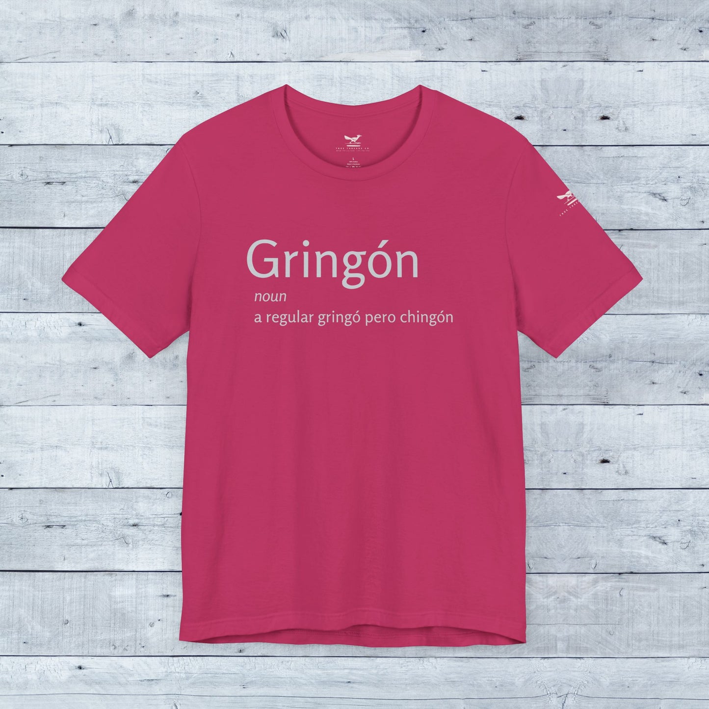Gringón Tee, a pink active shirt with bold white text, designed for comfort and style, blending cultural flair with a confident, casual fit.