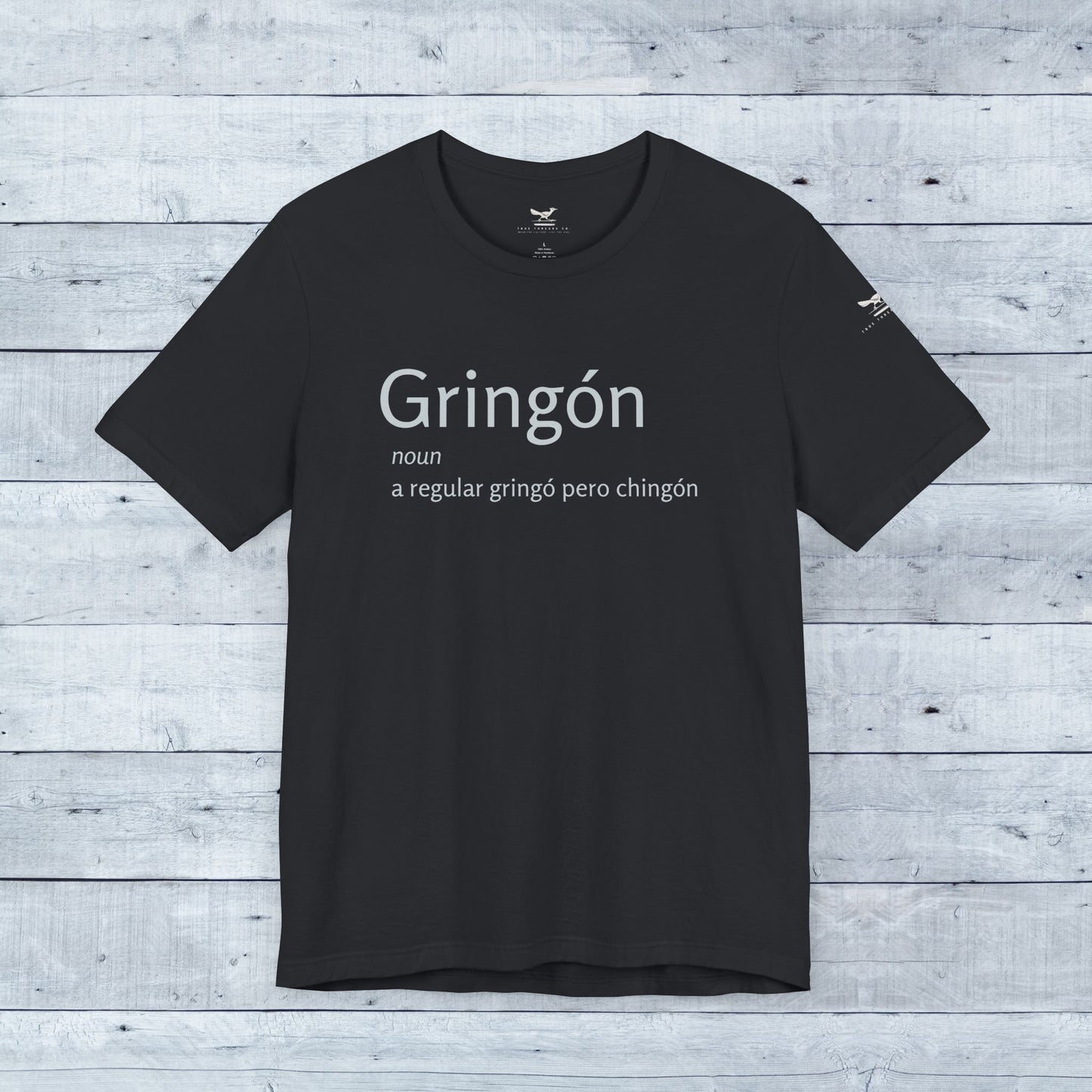 Close-up of the Gringón Tee, a black t-shirt with bold white text, embodying cultural fusion and confidence for any casual or semi-formal setting.