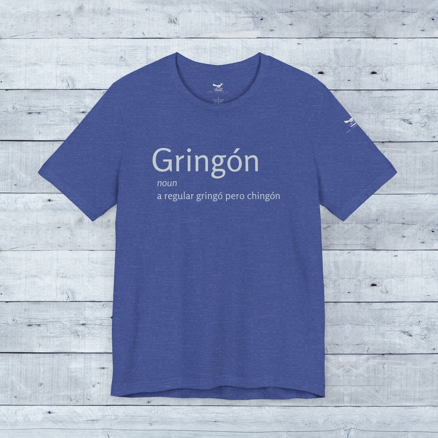 Gringón Tee showcasing bold white text on a blue t-shirt, crafted for comfort and style with a unisex fit and tear-away label.