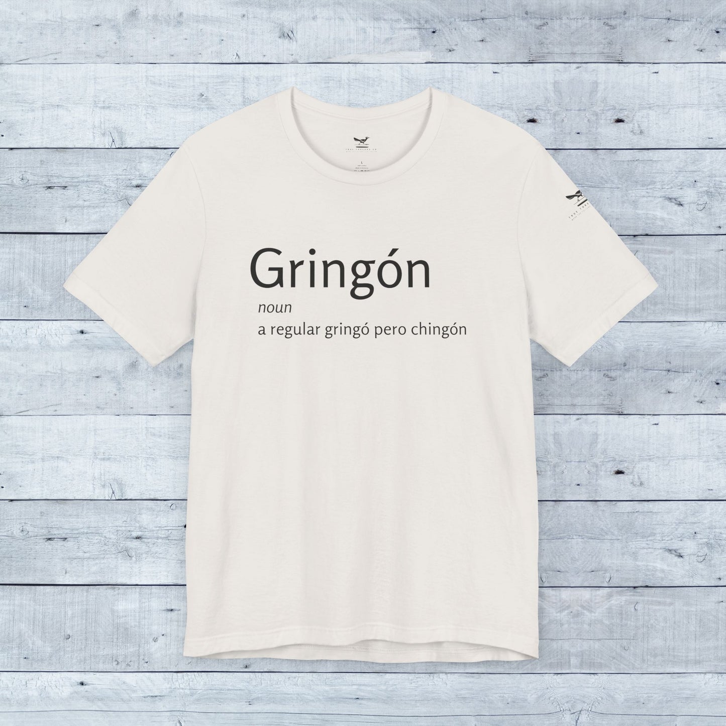 Gringón Tee: White crew neck t-shirt with bold black text, crafted from soft tri-blend fabric for comfort and style, perfect for active and casual wear.