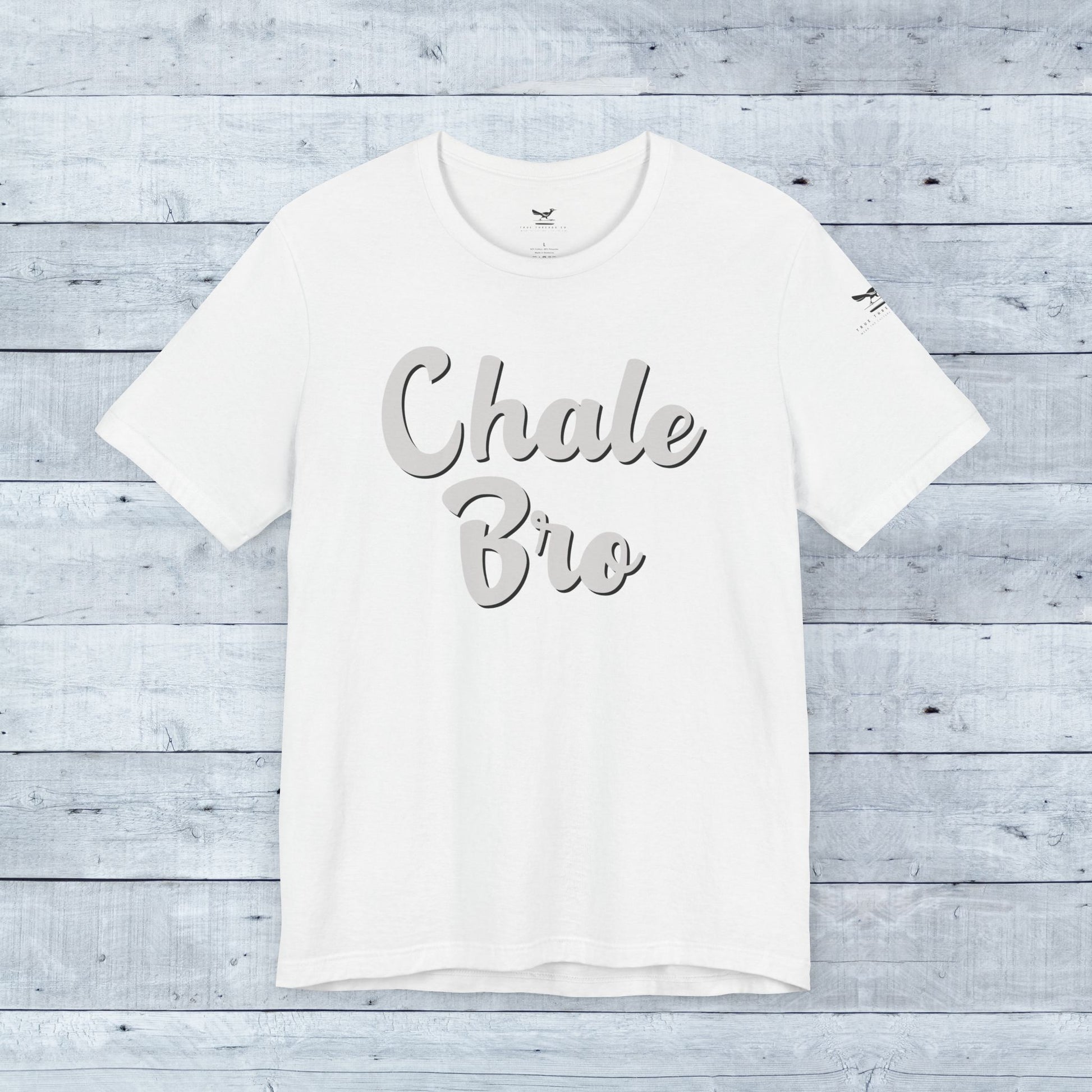 White relaxed fit tee with "Chale Bro" in gray cursive script across front.