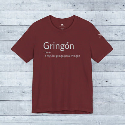 Gringón Tee featuring bold white text on a red background, crafted from soft tri-blend fabric, designed for comfort and style, suitable for casual wear.