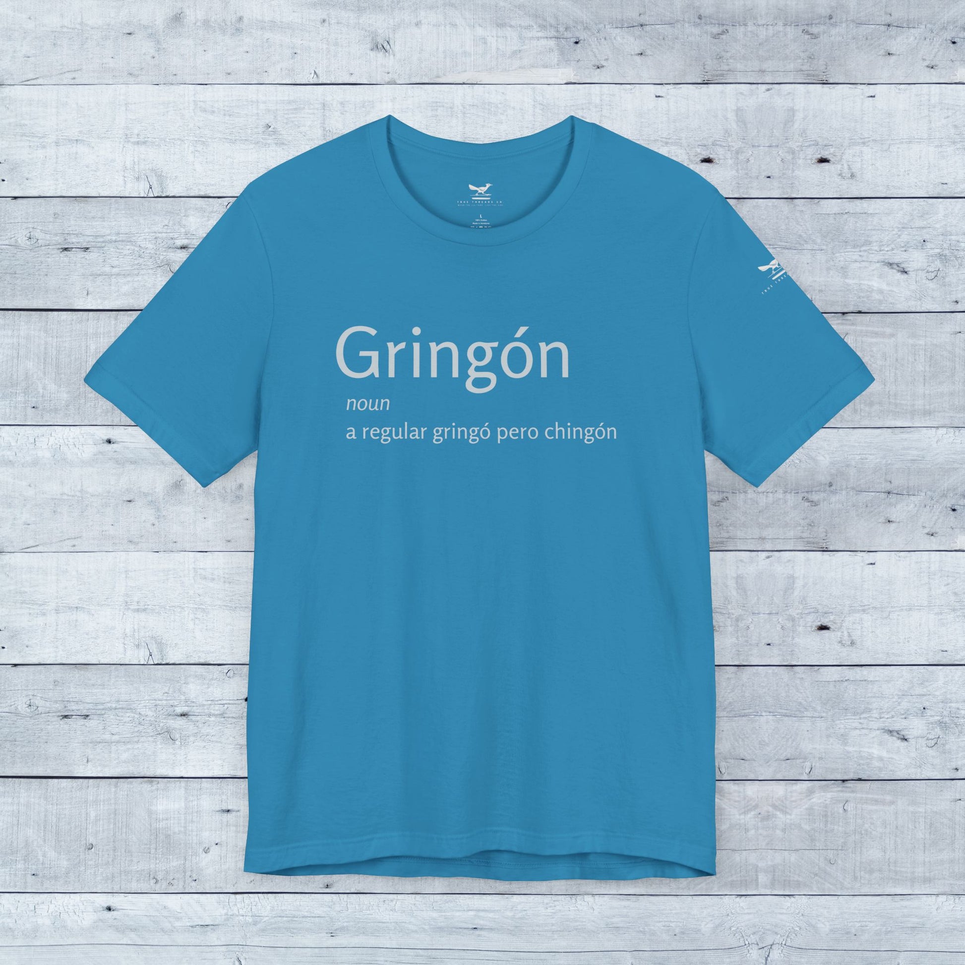 Gringón Tee: Blue shirt with bold white text, showcasing a fusion of cultures. Soft tri-blend fabric, unisex fit, perfect for confident, stylish wear.