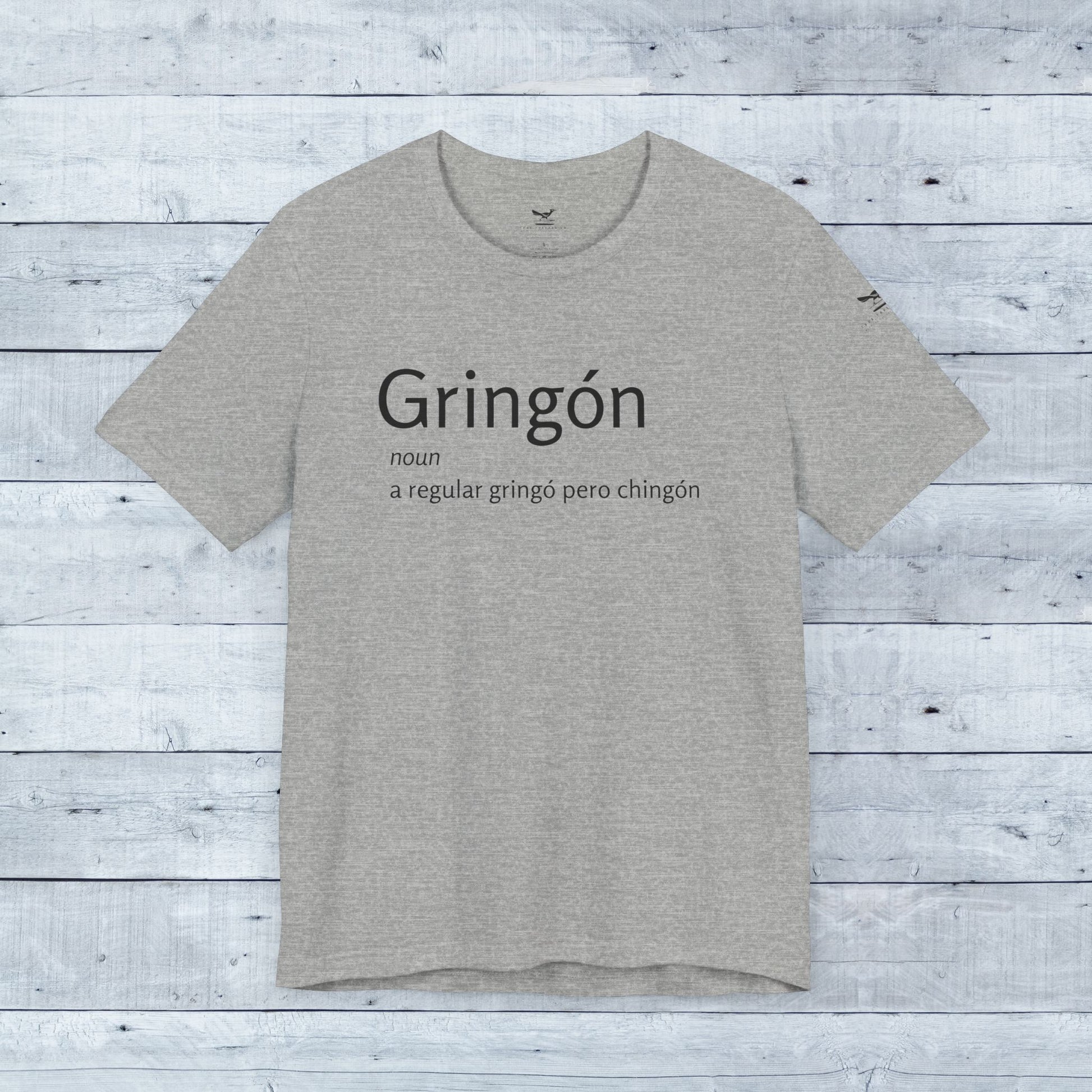 Gringón Tee: Grey t-shirt with bold black text, crafted from soft tri-blend fabric, offering comfort and style for both casual and semi-formal occasions.