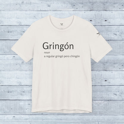 Gringón Tee: White crew neck t-shirt with bold black text, crafted from soft tri-blend fabric for comfort and style, perfect for active and casual wear.